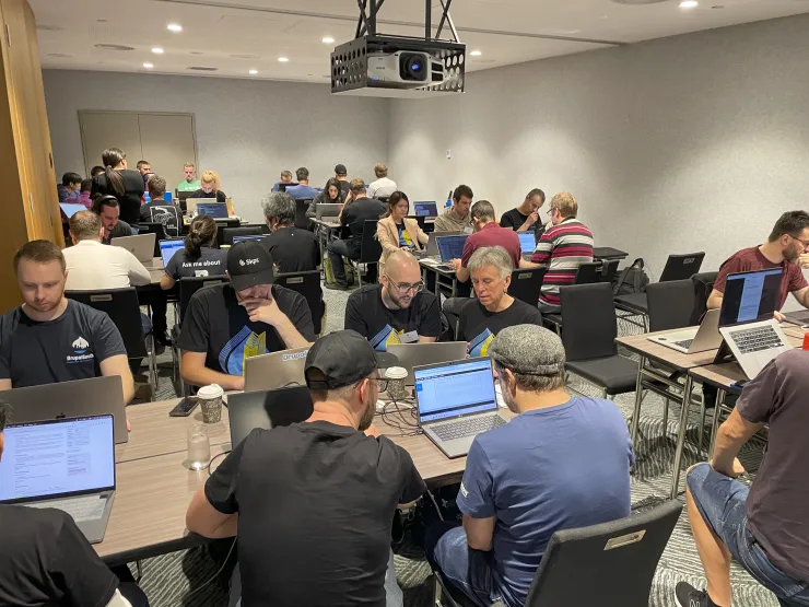 A room full of Drupal community members works together to improved Drupal during Drupal South Brisbane 2022